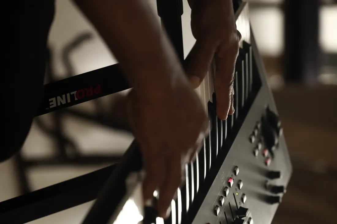 Hands playing a keyboard during worship